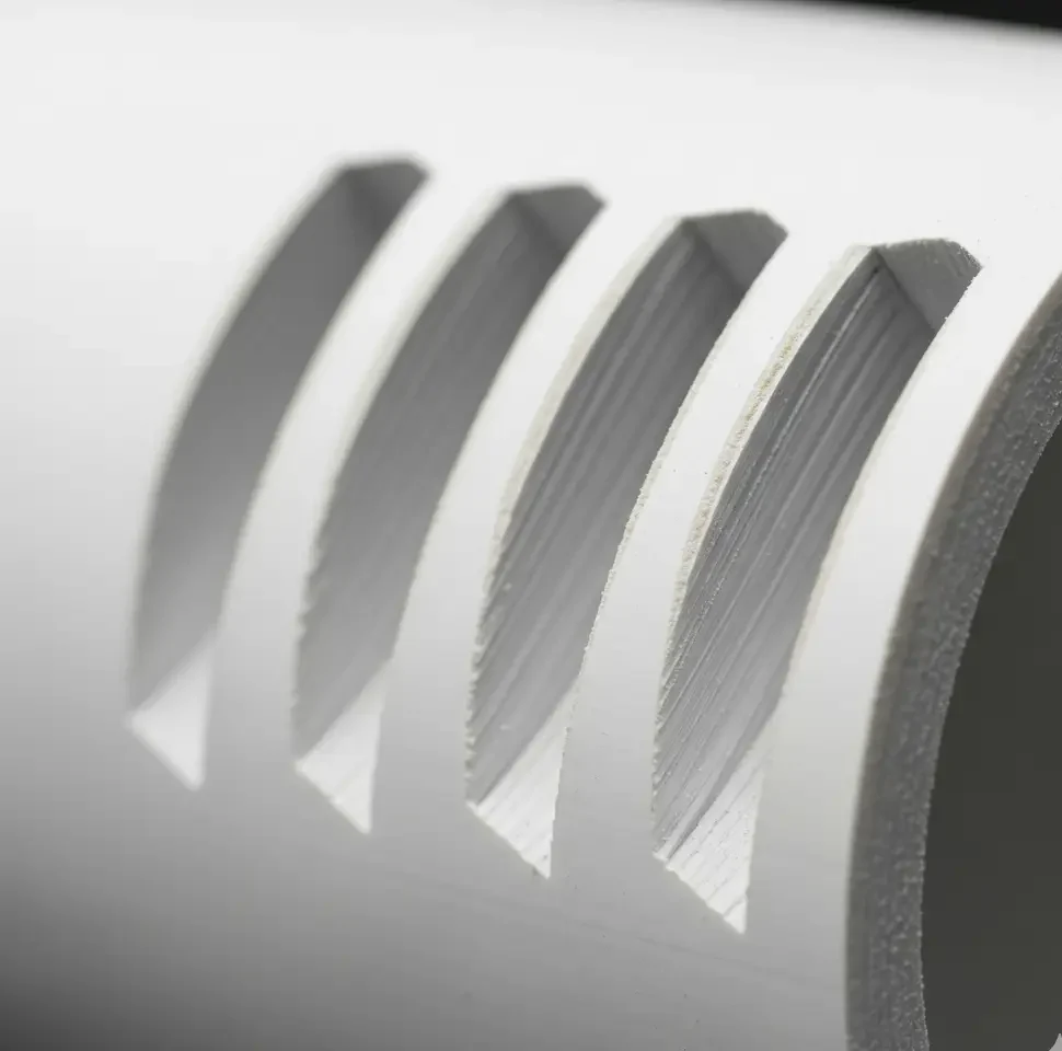 Close-up of 4-inch PVC pipe with sanded 45-degree holes for a vertical hydroponic tower.